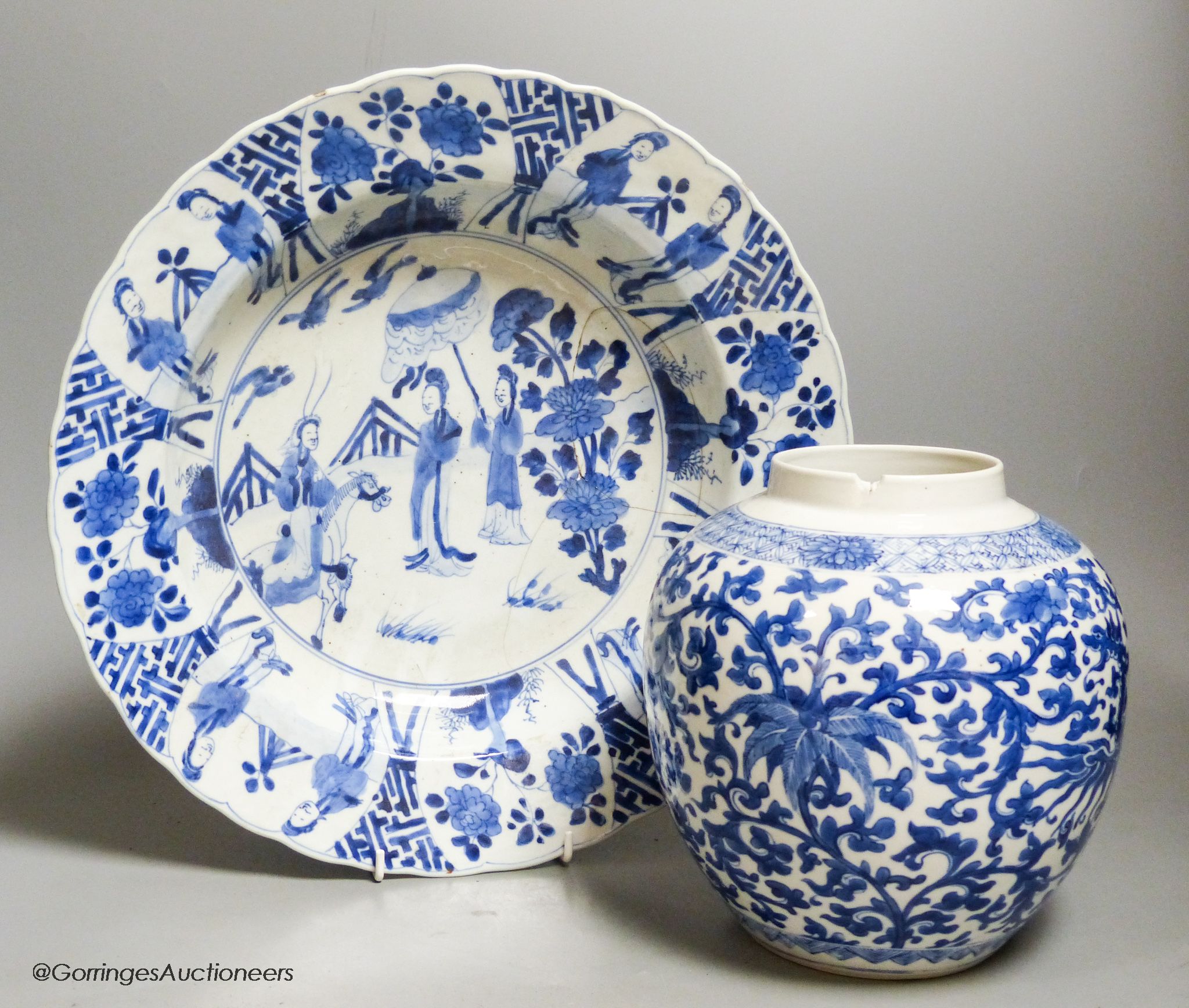 A Chinese blue and white dish, Kangxi mark and of the period, diameter 34cm, and a 19th century Chinese blue and white jar